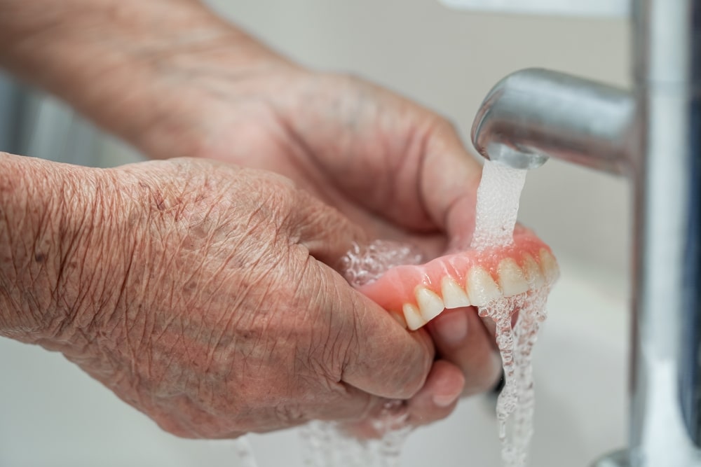 hands washing dentures